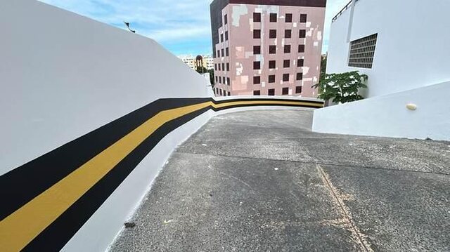 Rampa e muro da garagem do Residencial Bella Vista registrados durante a frente de pintura e acabamento.